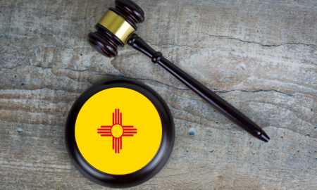 New Mexico child welfare Facebook lawsuit: Wooden judgement or auction mallet with of New Mexico flag