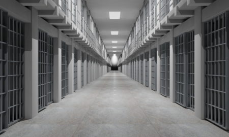 Teen Life Sentence Unjust: White hallway lined with barred prison cells