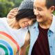 LGBTQ youth from immigrant families report: two happy LGBTQ youth embracing
