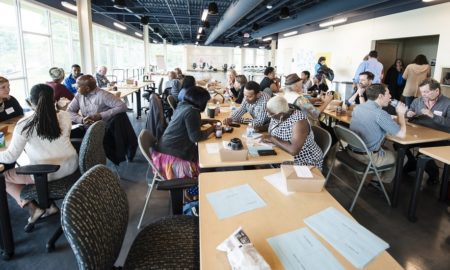 North Carolina education, environment, social, economic justice grants: group of activists working at tables