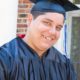 Helping Autistic Youth Transition to Adulthood Grants: autistic graduate student in graduation outfit