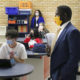 New Mexico Child Welfare Ranking: Adults wearing masks stand in classroom in front of students waring masks sitting at desks