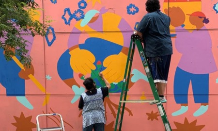 Oregon community grants: painters painting a colorful outdoor mural