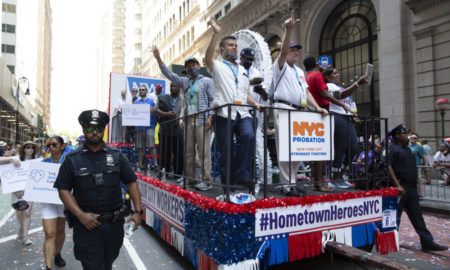 NYC Essential Workers Parade: red, white and blue float with people standing on it