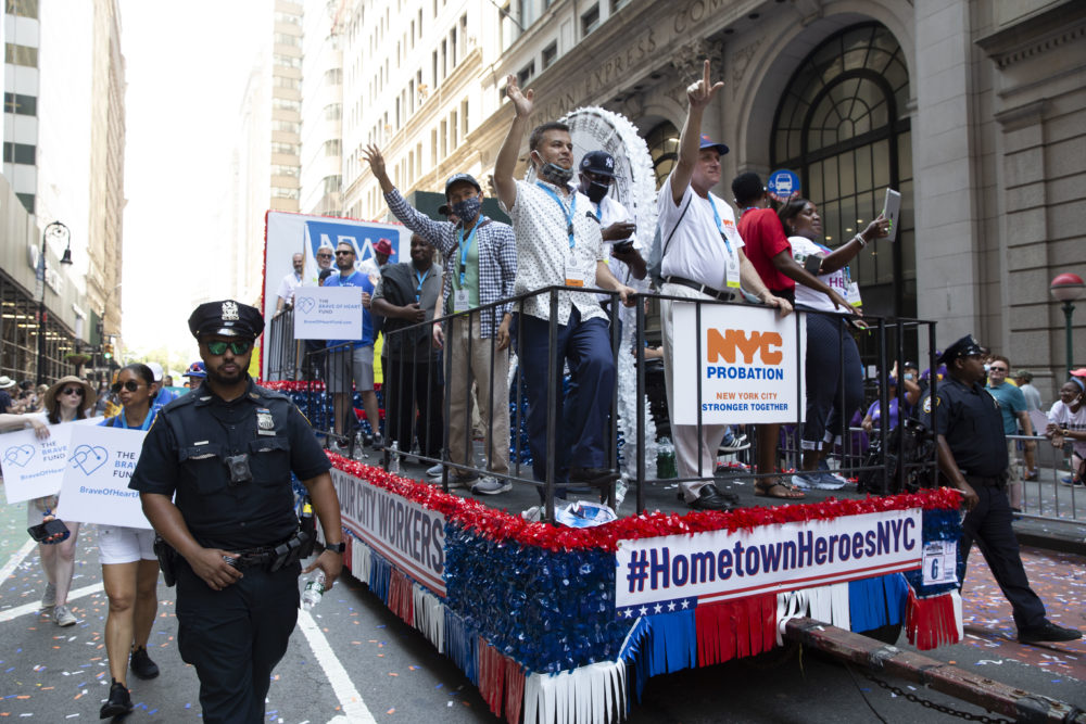 NYC Essential Workers Parade: red, white and blue float with people standing on it