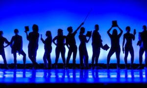 national young artist competition awards: silhouette of young theater performers on stage
