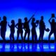 national young artist competition awards: silhouette of young theater performers on stage