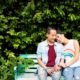 Northwest LGBTQ+ and black community COVID recovery grants: LGBTQ+ couple on park bench with bushes behind them