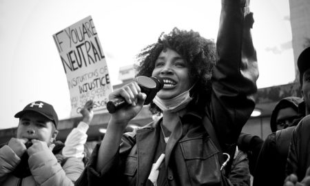 youth-led organizing and societal reform support grants: young woman of color leads a protest
