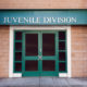 NY juvenile crime law: Green Double door entry to brick building with "Juvenile Division" sign above doors