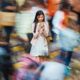 empowering the workforce of tomorrow report cover: young Asian woman on phone while crowds go by