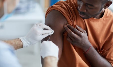 Vaccine equity resource hub project grant: black male getting vaccine in clinic