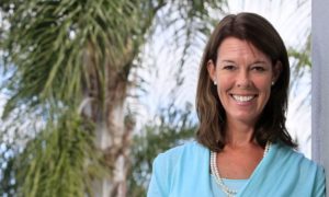 YMCA names Suzanne McCormick first woman president and CEO: smiling, brunette woman in front of palm trees