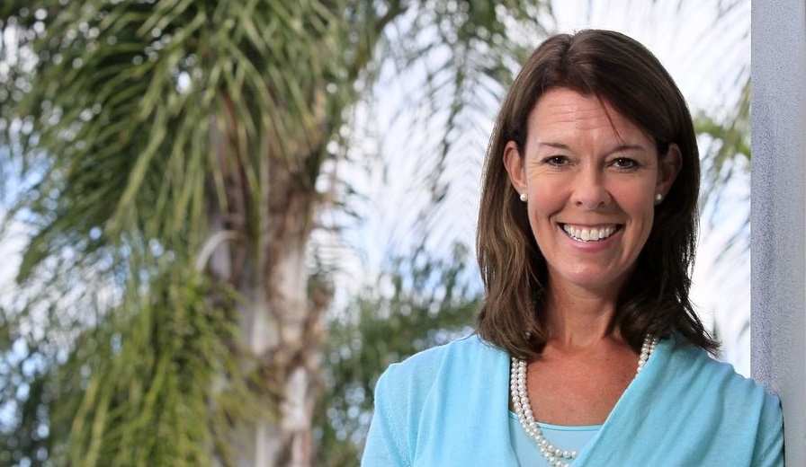 YMCA names Suzanne McCormick first woman president and CEO: smiling, brunette woman in front of palm trees