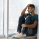 Black LGBTQ+ youth report: upset teen of color looking out window