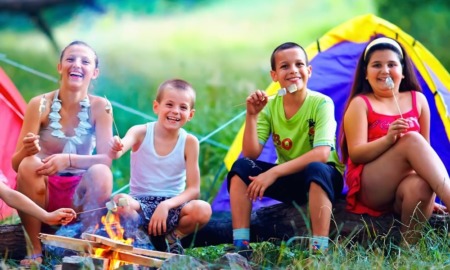 West Michigan child and youth grants: group of happy kids at campsite