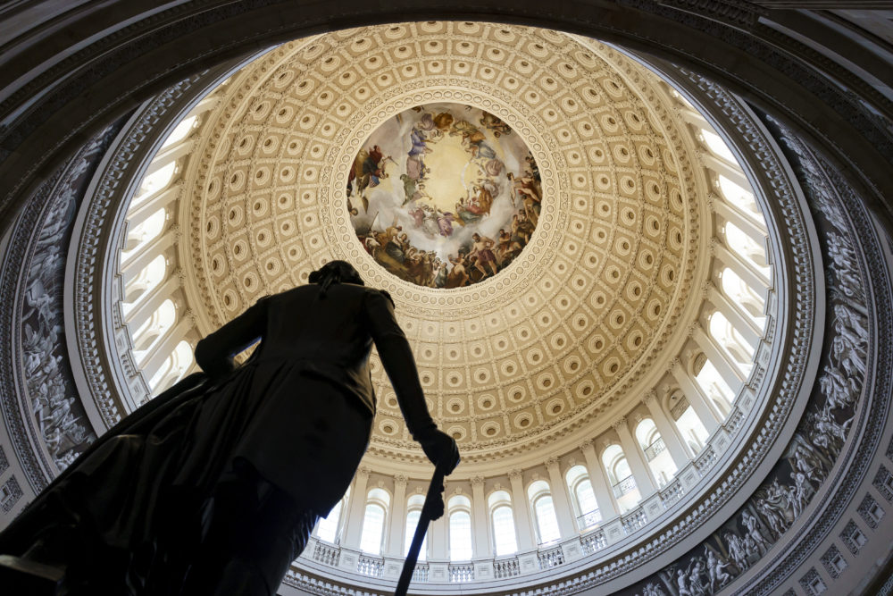 Pandemic aid to foster youth: View looking up into Rotunda of the U.S. Capitol with paintng n the center, gold dome interior and tall, arched windows all around