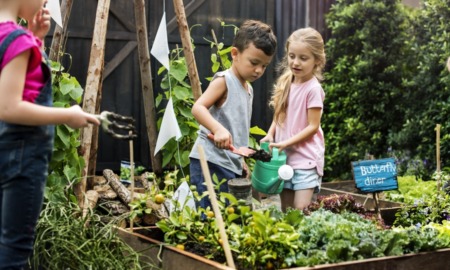 school garden grants; children watering plants in garden