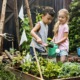 school garden grants; children watering plants in garden