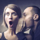 fundraising secret: man whispers into the ear of woman with shocked expression on her face
