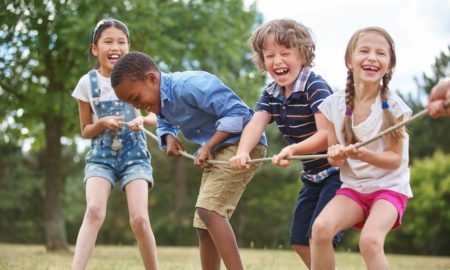 East-Central Indiana youth organization support grants: diverse kids playing tug of war