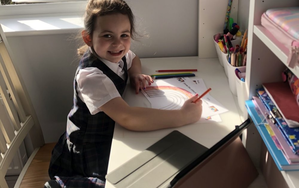 Some disabled students and parents want remote learning permanent option: little girl doing school work at home desk with tablet