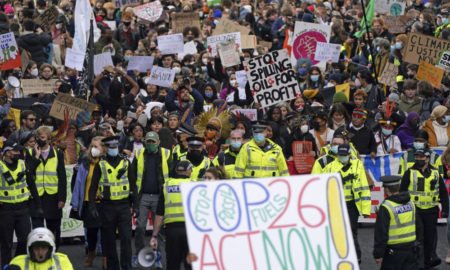 Climate COP26 Summit: Crowd of 100s with portest signs in the streets outside the conference