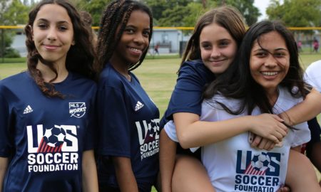 increasing underserved girls' youth soccer participation: group of diverse young girls in soccer shirts