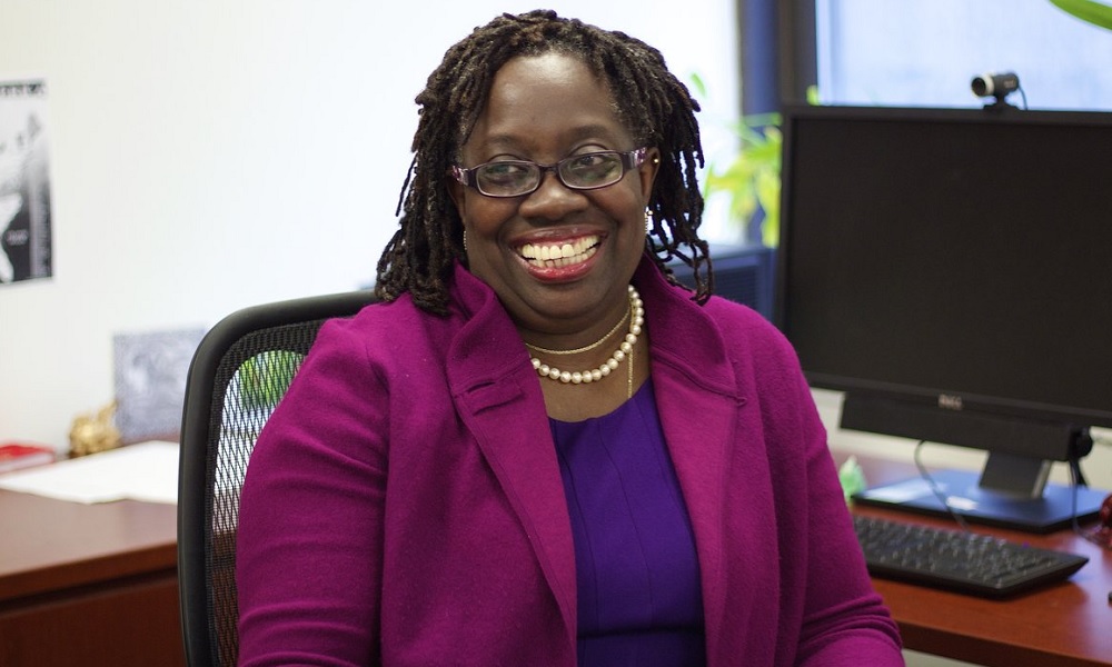 Denise Scott new president of LISC: black woman with glasses sitting in office chair smiling
