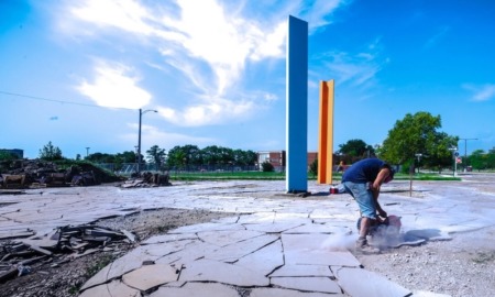Detroit area community project grants: man using saw to break apart cement
