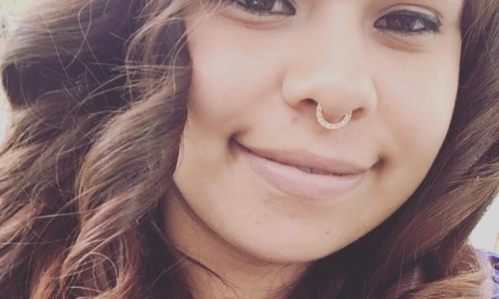 months after pandemic aid, foster youth struggling: happy, young Latina woman with nose ring