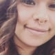 months after pandemic aid, foster youth struggling: happy, young Latina woman with nose ring