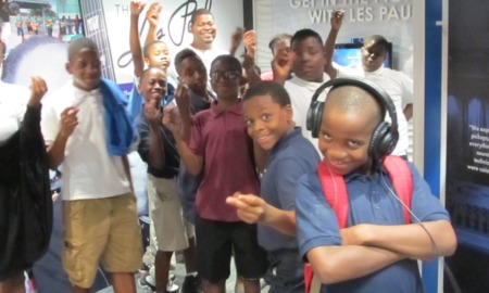 music education, STEM and hearing impairment grants: group of black youths listening to music and learning
