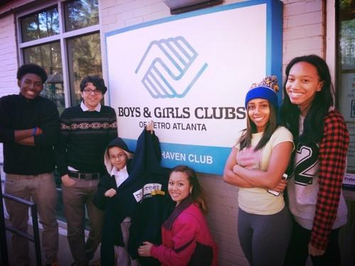 BOOST: Six teens stand in front of Boys & Girls Club sign