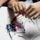 optics and photonics STEM education grants: hands working on electronic STEM project