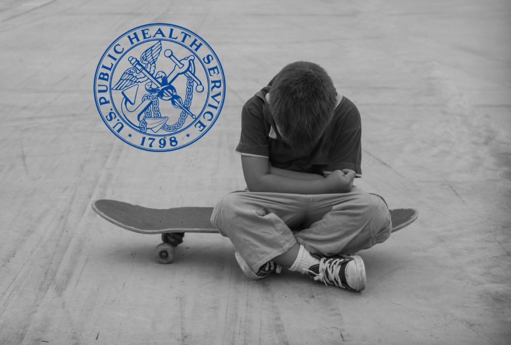 US surgeon general youth mental health advisory: public health service logo next to young dark-haired boy sitting on skateboard with arms wrapped around himself and head hanging down