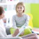 children's mental healthcare access improvement research grants; young girl happy with therapist