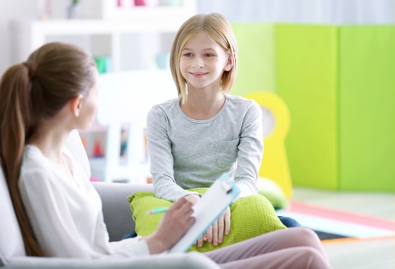 children's mental healthcare , child psychology research grants: young girl happy with therapist