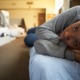 youth service grants: young, black girl laying on shelter bed looking sad