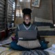 digital learning for every child report: young black girl in metal shack learning on laptop