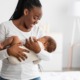 infant mortality racial disparity grants: happy black mother and baby in white room