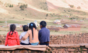 Native American community grants: four children sitting and looking over rural land