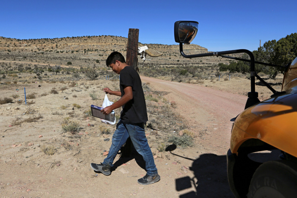New Mexico Starlink internet: Teen bot walks away from schoolbus at the side of a dirt road.