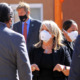 New Mexico Educaton Plan: Group of adults in business attire wearing masks stand ina group talking to each other