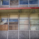 Juvenile reform: multiple metal-framed windows of abandoned multi-story building