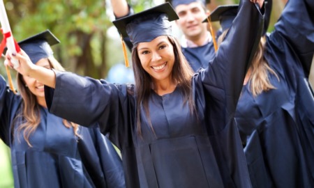DEI in colleges: young woman in graduation garb celebrating
