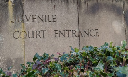 juvenile court: stone entrance to juvenile court building with flowers in front