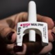 youth overdose renews pleas for Narcan in schools: hand holding Narcan nasal spray on black background