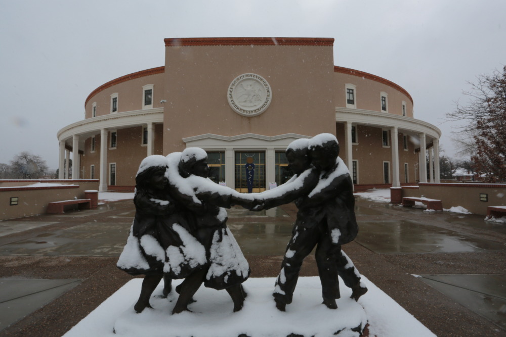 New Mexico passes new child protection law: statue of children playing outside New Mexico state Capitol in the snow