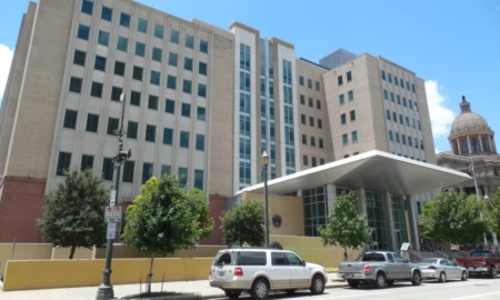 Houston-area justice-involved youth repeat offenders: county juvenile court building against blue sky
